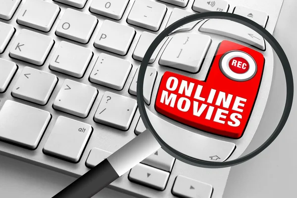 Computer keyboard with red online movies button and magnifying glass — Stock Photo, Image