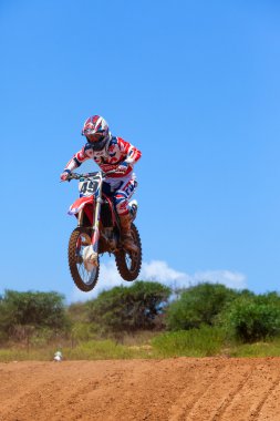 Wingate, Israel - July 23, 2016: Motocross rider and bike clearing a tabletop jump during the final heat of the race