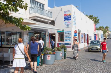 Santorini, Greece - August 7, 2016: Tourists at Santorini's Famous cliff-top village of Fira, known for its shops and amazing view to the volcano