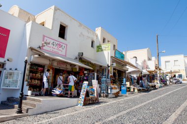 Santorini, Greece - August 7, 2016: Tourists at Santorini's Famous cliff-top village of Fira, known for its shops and amazing view to the volcano 
