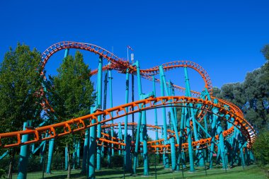 Biddinghuizen, The Netherlands - August 24, 2016: People riding a High speed orange rollercoaster at Walibi theme park. 