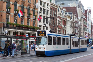 Amsterdam, The Netherlands - August 29, 2016: Tram (rail vehicle which runs on tracks along public urban streets) next to dam square, Amsterdam, The Netherlands 