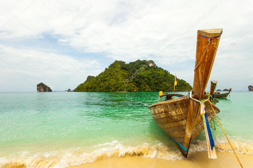 Traditional Thai long tail boat with thai island in the background