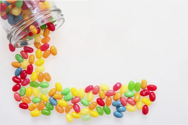 Jelly beans with a glass jar — Stock Photo, Image