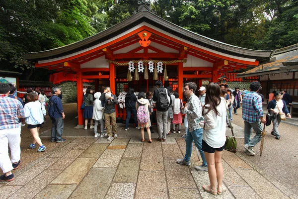 Japanese people and tourists at Fushimi Inari Shrine in Kyoto