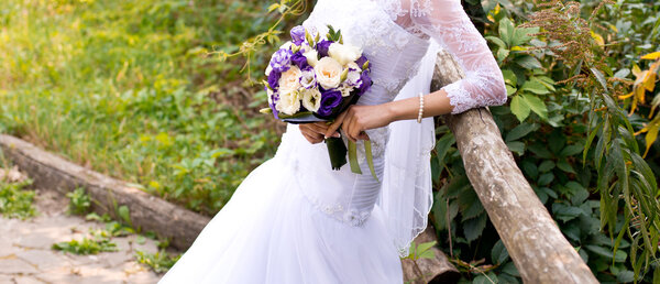 Elegant bride holding wedding bouquet