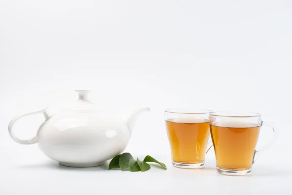 green tea leaves with tea on white background