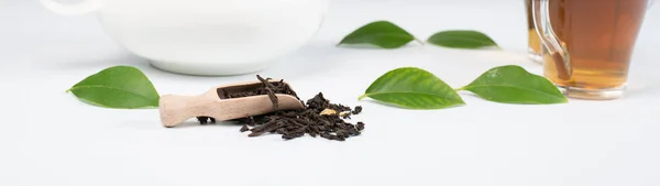 green tea leaves with tea on white background