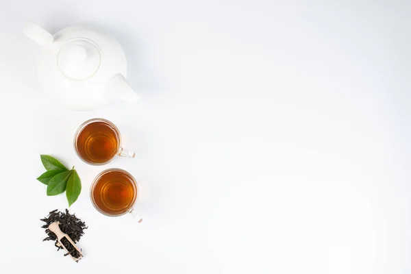 green tea leaves with tea on white background