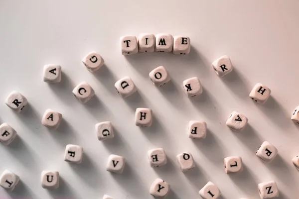 Time - the words written on wood blocks, white table, black and white letters — Stock Photo, Image