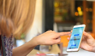 Genç bir kız akıllı telefon ekranını işaret ediyor. İnternet 'te bilgi aramak için cep telefonu kullanan ya da mobil uygulama kullanan bir kadın