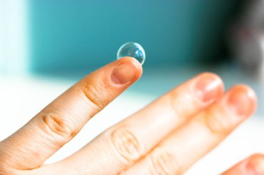 Bir çocuğun parmağının ucundaki sabun köpüğü. Çocuk oyunları ve eğlence. Tasasız çocukluk kavramı. Mavi arka plan. Yüksek kalite fotoğraf