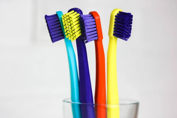 Set Plastic Multicolored Toothbrushes Green Blue Red Purple Transparent Glass — Stock Photo, Image