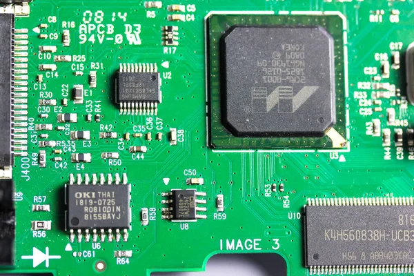 A green electronic circuit board flatly. Top view of pcb board circuit close-up. Radio amateur designs for electrically and mechanically connecting various electronic components. Technology background