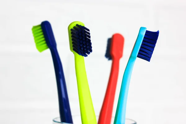 Set Plastic Multicolored Toothbrushes Green Blue Red Purple Transparent Glass — Stock Photo, Image