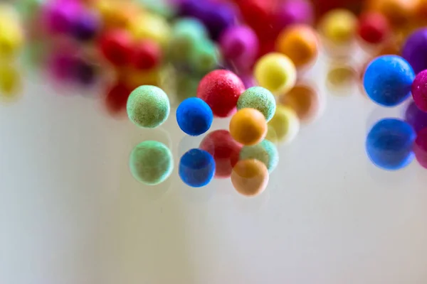 Foam Polystyrene Bright Colorful Beads Reflected Surface Glass Mirror Multicolored — Stock Photo, Image