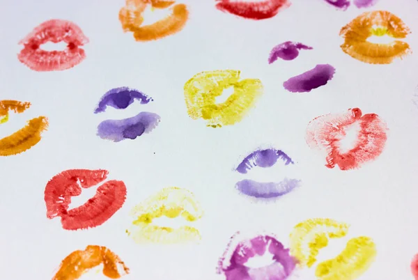 Set of multicolored female lip prints on white paper background top view. Kisses flatly. Lipstick prints, marks. Femininity, flirt, love concept. World Kissing Day. Valentine\'s Day. Lovely backdrop.