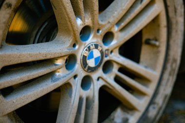 Kyiv, Ukraine 2 October 2025 Close-up of a dirty car wheel tire. The wheel and tire are covered in mud and dirt, suggesting off-road driving or travel on unpaved roads. Flat tire. Off road drive.
