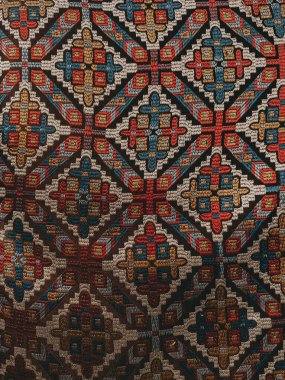 Geometrik şekilleri ve canlı renkleri olan karmaşık tekstil deseni. Bu detaylı tekstil, arka plan ve dokular için mükemmel, tekrar eden elmas ve çapraz motiflere sahip karmaşık bir tasarım sergiliyor.. 