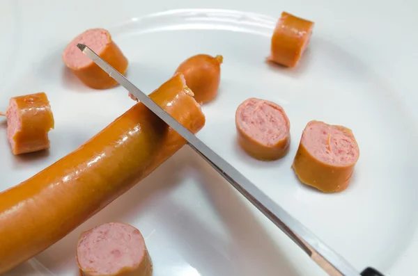 Vienna sausages cut with scissors.