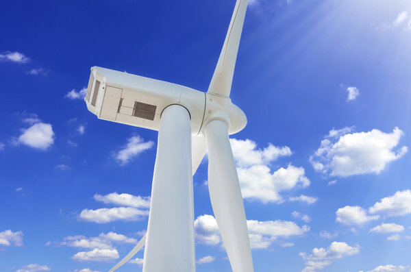 Wind turbine for alternative energy in front blue sky. Wind turbine