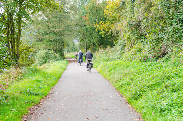 Group of cyclists on the river Ruhr in Essen Werden