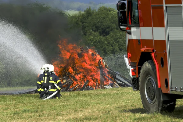Bombeiros extinguem veículo de incêndio — Fotografia de Stock