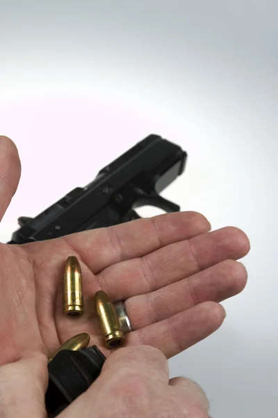 Man pointing a weapon and weapon charges — Stock Photo, Image