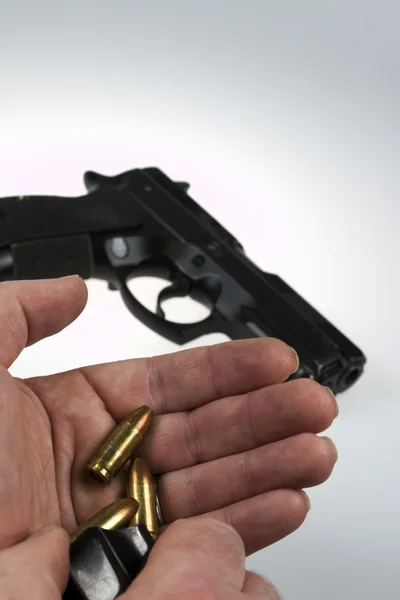 Man pointing a weapon and weapon charges — Stock Photo, Image