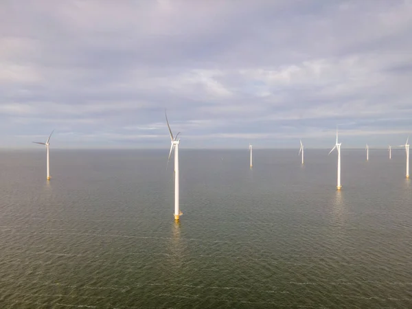 Offshore windmill park with clouds and a blue sky, windmill park in the ocean drone aerial view with wind turbine — Stock Photo, Image