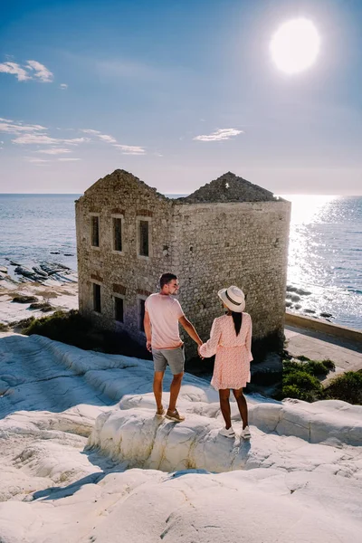 Punta Bianca Sicily, couple watching sunset at the white cliffs with abandoned house at Punta Bianca Sicilia Ital — Stock Photo, Image