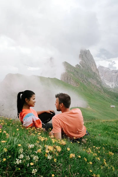 Couple mid age men and woman visiting the Italian Dolomites in Italy Seceda peak — Stock Photo, Image