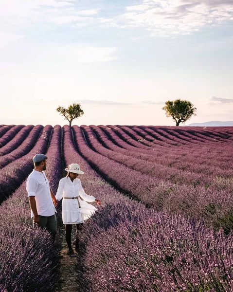 couple mid age men and woman on vacation in the Provence visiting the blooming lavender fields in France
