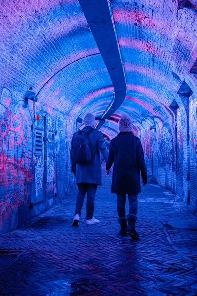 Colorful green, blue, pink illuminated Ganzemarkt tunnel in the centre of Utrecht, The Netherlands — Stock Photo, Image