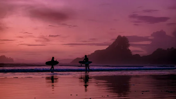 Tofino Vancouver Island Pacific rim costa, surfistas com bordo durante o pôr do sol na praia, surfistas silhueta Canadá Vancouver Island Tofino. — Fotografia de Stock