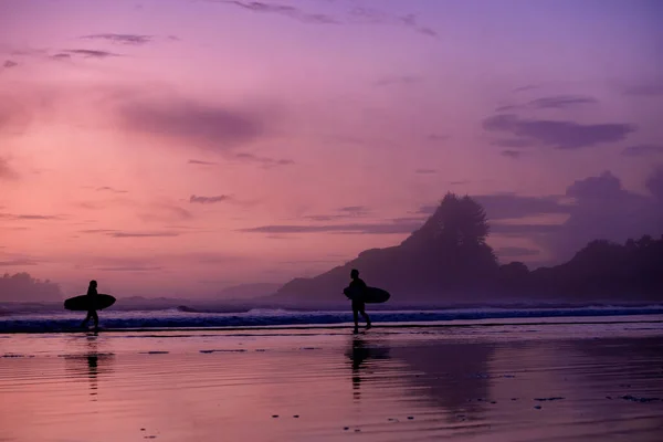 Tofino Vancouver Island Pacific rim coast, surfers with board during sunset at the beach, surfers silhouette Canada Vancouver Island Tofino.