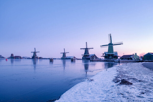 snow covered windmill village in the Zaanse Schans Netherlands, historical wooden windmills in winter Zaanse Schans Holland