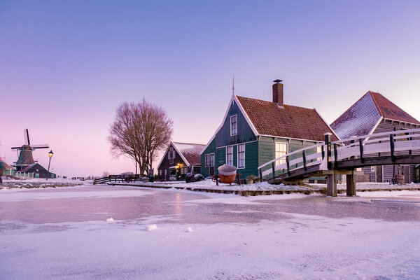 snow covered windmill village in the Zaanse Schans Netherlands, historical wooden windmills in winter Zaanse Schans Holland