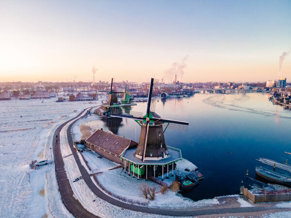 snow covered windmill village in the Zaanse Schans Netherlands, historical wooden windmills in winter Zaanse Schans Holland