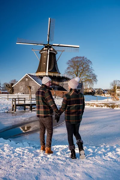 Pelmolen Ter Horst, Rijssen covered in snowy landscape in Overijssel Netherlands, historical wind mill during winter with white landscape