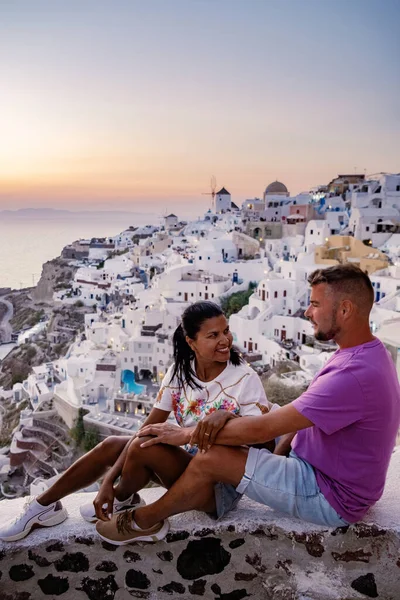 Santorini Greece, young couple mid age European and Asian on vacation at the Greek village of Oia Santorini Greece, luxury vacation Santorini — Stock Photo, Image
