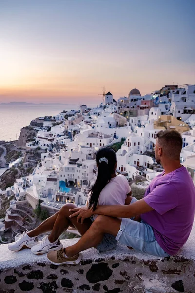 Santorini Greece, young couple mid age European and Asian on vacation at the Greek village of Oia Santorini Greece, luxury vacation Santorini — Stock Photo, Image