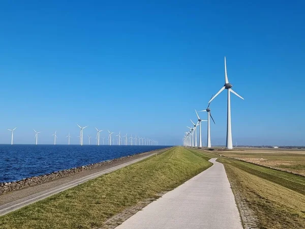 Windmill village indrustial wind mill by the lake Ijsselmeer Nehterlands