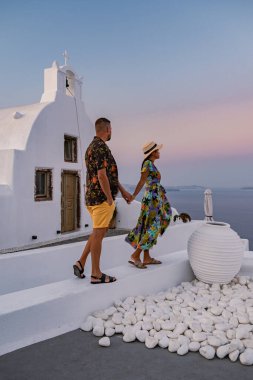 Santorini Yunanistan, orta yaşlı Avrupalı ve Asyalı genç çift Yunanistan 'ın Oia Santorini köyünde tatilde, Santorini' de lüks tatil