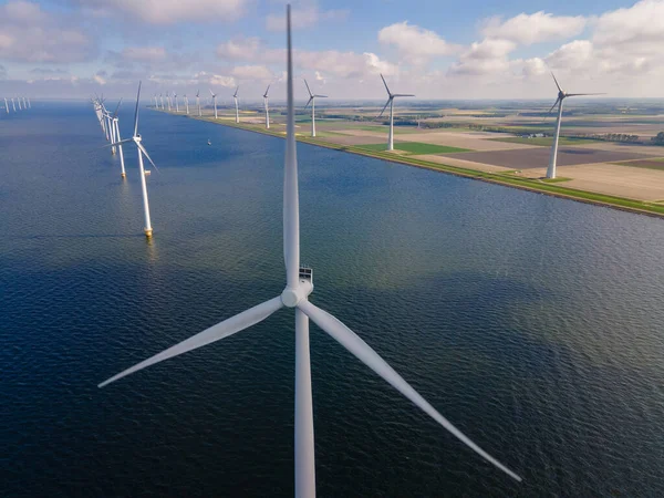 Offshore windmill park with clouds and a blue sky, windmill park in the ocean drone aerial view with wind turbine Flevoland Netherlands Ijsselmeer — Stock Photo, Image