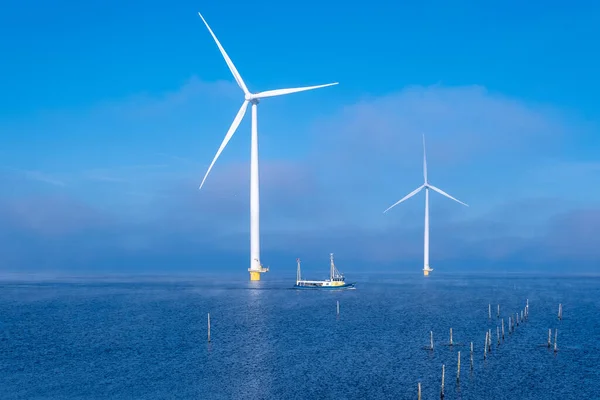 Offshore windmill park with clouds and a blue sky, windmill park in the ocean drone aerial view with wind turbine Flevoland Netherlands Ijsselmeer — Stock Photo, Image