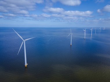 Bulutları ve mavi gökyüzü olan off-shore yel değirmeni parkı, okyanus drone parkı rüzgar türbini Flevoland Hollanda Ijsselmeer ile hava manzaralı