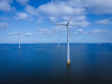 Bulutları ve mavi gökyüzü olan off-shore yel değirmeni parkı, okyanus drone parkı rüzgar türbini Flevoland Hollanda Ijsselmeer ile hava manzaralı
