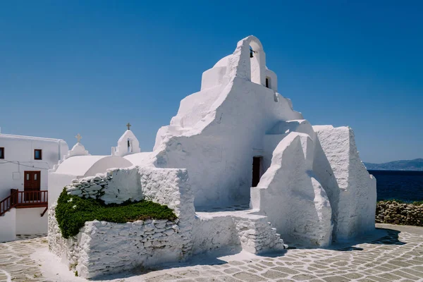 Mykonos Greece , old church of the old town of Mykonos with tourist in the street — Stock Photo, Image