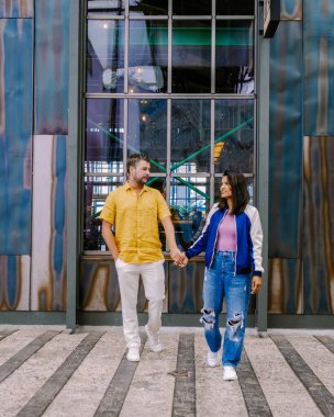 Amsterdam Kinetisch Noord adındaki NDSM Wharf Amsterdam sanat camiası, Amsterdam 'daki yeraltı kültürü merkezi plaj otelleri ve restoranları yaklaşıyor, Amsterdam Noord' u ziyaret eden çift ve kadın.